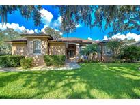Charming single-story home with a well-maintained lawn, lush landscaping, and a welcoming facade at 10130 Paddock Oaks Dr, Riverview, FL 33569