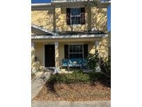 Charming two-story townhouse with covered front porch and seating area at 4632 Chatterton Way, Riverview, FL 33578