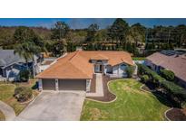A well-maintained single Gathering home with an attached two car garage and manicured lawn at 5342 Sagamore Ct, New Port Richey, FL 34655