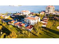An inviting aerial view of the condo community, showcasing mature trees and direct access to the waterfront at 6269 Palma Del Mar S Blvd # 111, St Petersburg, FL 33715