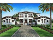 Stunning two-story home features manicured landscaping, symmetrical design, a brick driveway, and balcony at 1 Avonwood, Tampa, FL 33625