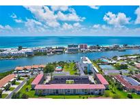 Breathtaking aerial view of a beachfront community with stunning blue ocean and lush tropical surroundings at 10215 Regal Dr # 45, Largo, FL 33774
