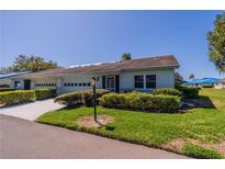 Charming home featuring a well-manicured lawn and mature landscaping, enhancing its curb appeal at 2720 Lancaster Dr, Sun City Center, FL 33573