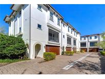 Beautiful three-story townhomes with a brick driveway and landscaping at 3215 W De Leon St # 6, Tampa, FL 33609
