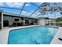 Inviting screened-in pool area with outdoor dining, barbecue and jacuzzi for enjoying a relaxing outdoor lifestyle at 4118 Ramona Dr, Spring Hill, FL 34606