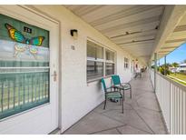 Inviting condo exterior with a door and seating area at 5227 81St N Ln # 15, St Petersburg, FL 33709