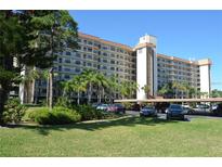 Multi-story condo building featuring balconies and parking with tropical landscaping in a sunny setting at 5400 Park N St # 200, St Petersburg, FL 33709
