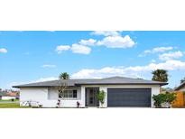Charming single-story home featuring a well-maintained lawn and an attached two-car garage at 5426 Creeping Hammock Dr, Sarasota, FL 34231