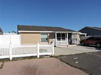 Charming single-story home featuring a picket fence and covered porch at 8813 Sleepy Creek Ct, Tampa, FL 33634