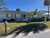 Charming one-story home with a well-maintained lawn and inviting curb appeal at 425 Highland Ct, Dunedin, FL 34698