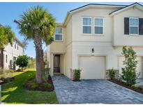 Charming townhouse features a one-car garage, beautifully landscaped front yard, and a welcoming entrance at 4272 Cloud Hopper Way, Lutz, FL 33559