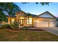 Inviting home with a well-manicured lawn, beautiful landscaping, and a two-car garage at 434 Arch Ridge Loop # 434, Seffner, FL 33584