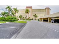 Beautiful condo building with palm trees and covered parking at 4750 Cove Cir # 706, St Petersburg, FL 33708