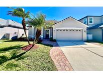 Charming home exterior featuring a two-car garage and lush landscaping at 1945 Fruitridge St, Brandon, FL 33510
