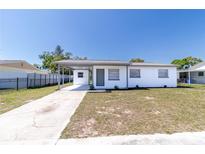 Charming single-story home with a covered carport and a well-maintained front lawn at 2413 Wishing Well Way, Tampa, FL 33619