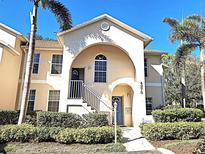Charming building exterior with beautiful architectural details and manicured landscaping at 4275 Castlebridge Ln # 1325, Sarasota, FL 34238
