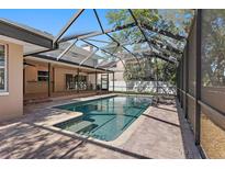 A screened-in pool features a brick surround and attached covered lanai at 902 Marco Ne Dr, St Petersburg, FL 33702