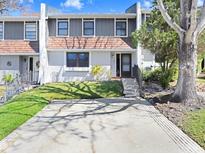 Charming townhouse featuring a two-story facade, well-maintained lawn, and a private driveway at 1331 Abbey Crescent Ln, Clearwater, FL 33759