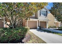Charming two-story townhome with an attached two-car garage and a well-maintained front yard at 2128 River Turia Cir # 2128, Riverview, FL 33578