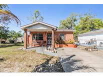 Charming single-story red brick home with a cozy front porch and well-maintained yard at 2410 E Palifox St, Tampa, FL 33610