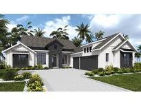 Charming two-story home with gray and white accents, palm trees, and a paver driveway at 5047 Summit View Dr, Brooksville, FL 34601