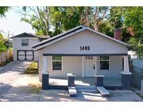 Charming one-story home with covered porch and well-maintained front yard at 1403 E Laura St, Plant City, FL 33563