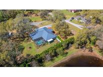 Aerial of home showing a screened-in pool and large yard at 37350 Neighbors Path, Zephyrhills, FL 33542