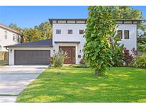 Beautiful two story home features a well maintained lawn, fresh landscaping and a two car garage at 4308 W Beach Park Dr, Tampa, FL 33609
