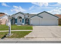 Charming single-story home with a well-maintained lawn and a two-car garage in a residential neighborhood at 9826 La Vonda St, Riverview, FL 33569