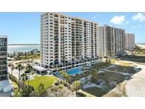 Beautiful high-rise condo with a beach view and a pool surrounded by palm trees on a sunny day at 1270 Gulf Blvd # 905, Clearwater Beach, FL 33767