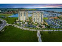 Stunning aerial view of the condominium towers, lush landscaping, boat marina and surrounding bay waters at 140 Riviera Dunes Way # 404, Palmetto, FL 34221