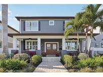 Charming two-story home with a landscaped front yard and inviting front porch and a beautiful double-door entry at 518 33Rd N Ave, St Petersburg, FL 33704