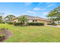 Lovely single-story home featuring a well-kept lawn, mature landscaping, and a convenient two-car garage at 1319 Leland Dr # 101, Sun City Center, FL 33573