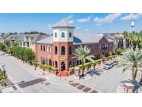 Corner building with red brick, a charming tower, street parking, and a view of the nearby water tower at 1810 E Palm Ave # 4304, Tampa, FL 33605