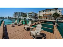 Beautiful waterfront property featuring a private dock with chairs and stunning views of the harbor at 479 E Shore Dr # 8, Clearwater, FL 33767