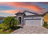 Charming single-Gathering home with well-manicured lawn and a two-car garage and beautiful stone accents at 12730 Oak Hill Way, Parrish, FL 34219