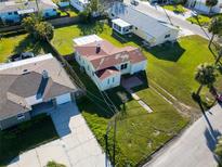 Aerial view of a single-Gathering home, showing the roof, lawn, and surrounding neighborhood at 15822 Redington Dr, Redington Beach, FL 33708