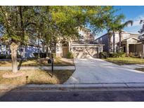 Charming two-story home featuring a well-manicured lawn and a spacious two-car garage at 20427 Carolina Cherry Ct, Tampa, FL 33647