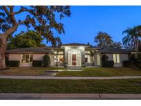 Stunning exterior of this well maintained home with mature landscaping and a stone entryway at 217 Manatee Rd, Belleair, FL 33756
