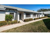 Charming villa with manicured landscaping and inviting entryway at 2749 Countryside Blvd # 28, Clearwater, FL 33761
