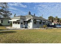 Charming single-story home with awning-covered windows, a gray roof, and a well-maintained lawn at 3001 57Th S St, Gulfport, FL 33707