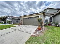 Two-car garage with stone accents and well-maintained landscaping add curb appeal to this lovely home at 31818 Blythewood Way, Wesley Chapel, FL 33543