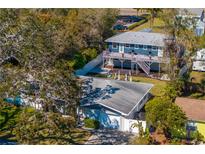 Aerial view showcases lush greenery, two-story home with a balcony, and charming single-story home at 5713 23Rd S Ave, Gulfport, FL 33707