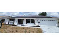 Charming single-story home with solar panels, a well-manicured lawn, and inviting curb appeal at 663 Allegheny Dr, Sun City Center, FL 33573