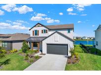 Charming two-story home boasts a modern farmhouse aesthetic with a well-manicured lawn at 8337 Abalone Loop, Parrish, FL 34219