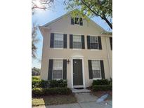 Charming two-story home with green shutters, a well-manicured lawn, and lovely landscaping at 10002 Bradwell Pl, Tampa, FL 33626
