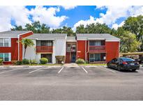 Condominium exterior with red brick accents, and well-maintained landscaping at 1055 82Nd N Ter # 1055A, St Petersburg, FL 33702