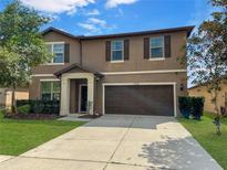 Charming two-story home with a well-maintained lawn and inviting curb appeal at 1848 Trillium Blvd, Brooksville, FL 34604