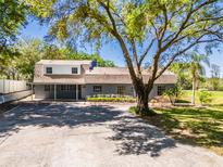 Charming home boasts a large front yard, mature trees, and ample parking space at 498 Lakewood Dr, Brandon, FL 33510
