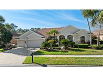 Charming home with a well-manicured lawn, mature landscaping, and a welcoming two-car garage at 10561 Greencrest Dr, Tampa, FL 33626